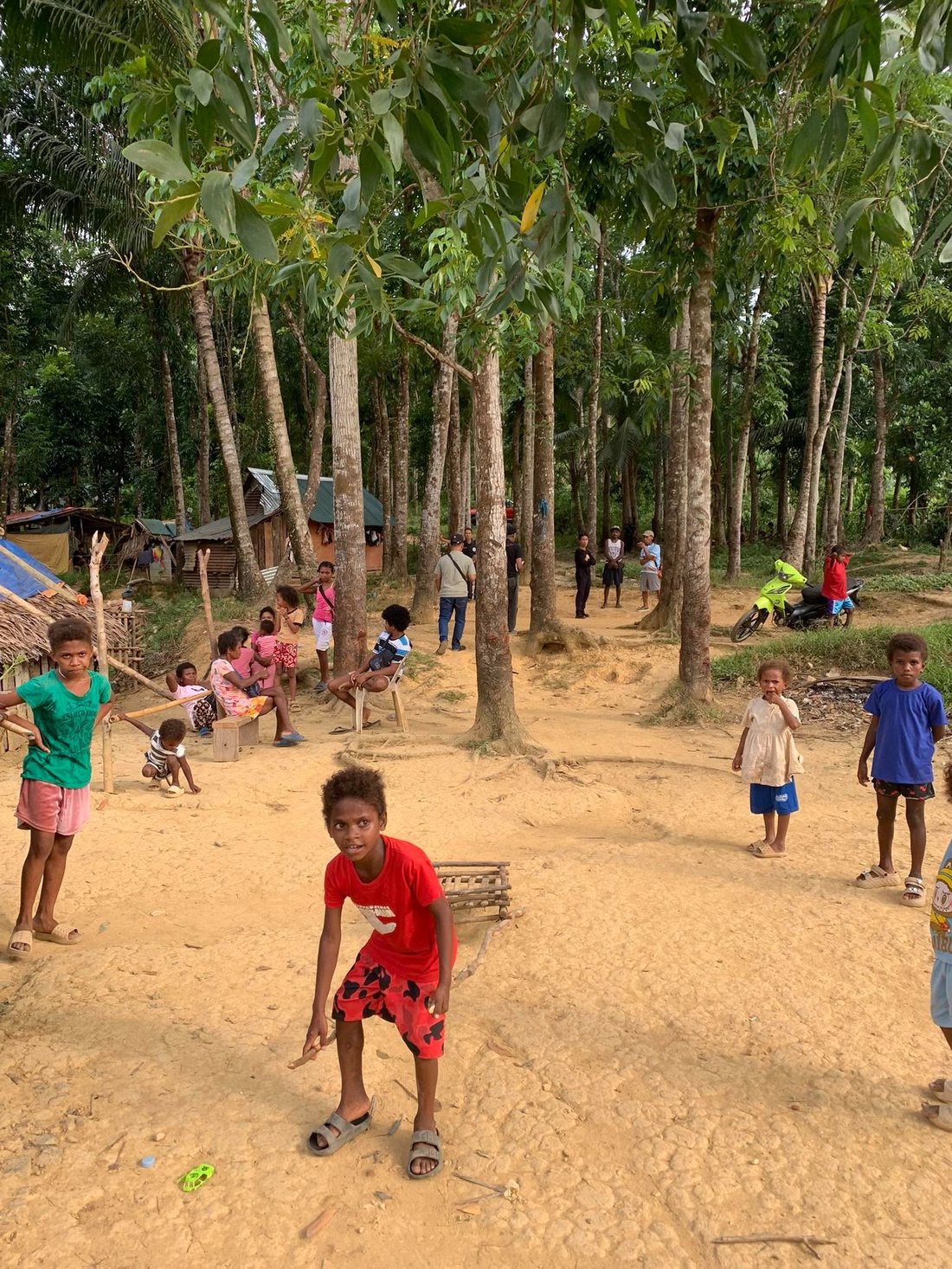 Children of the Aeta community playing under the trees in Tumbaga, San Rafael