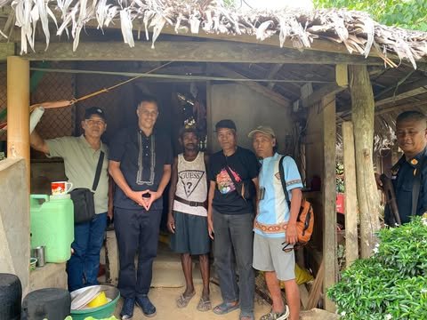 Visitors from the association with members of the Aeta community outside a home in Tumbaga, San Rafael