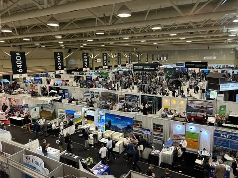 The busy exhibition floor of an international mining convention, seen from above