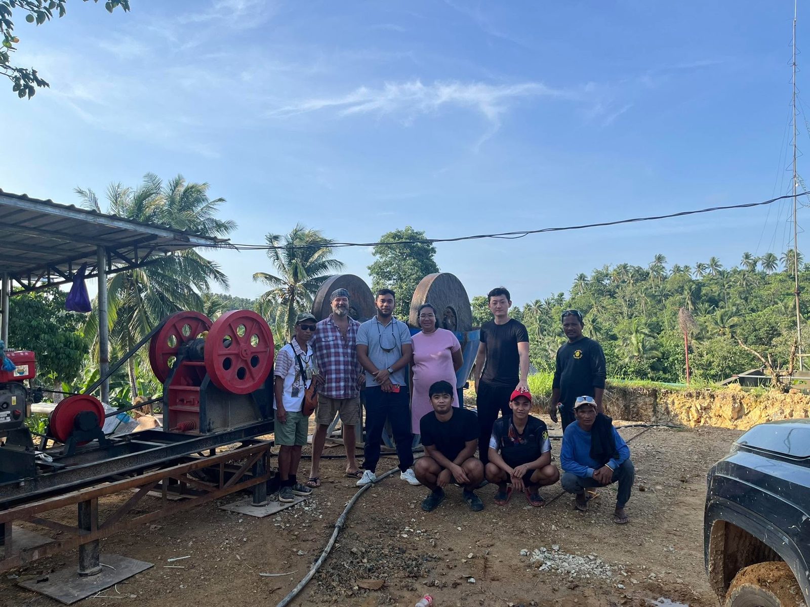 Founding members of the Capacuan Minahang Bayan standing beside the jaw crusher and wet pan mill