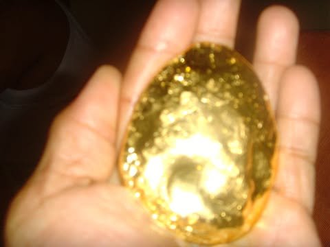 A large piece of gold held in an open hand