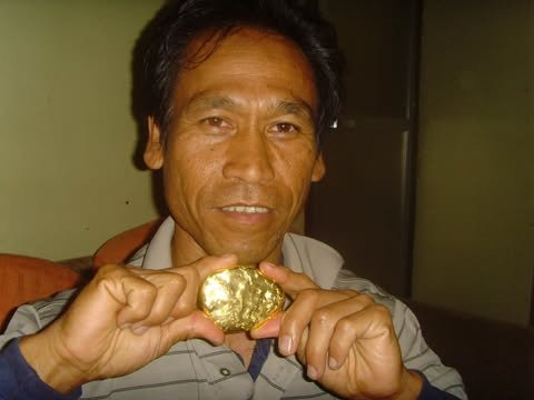 Allan Inocalla holds up a large piece of gold recovered on the Inocalla family land